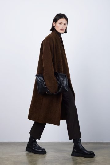 Brown Collarless Shearling Wrap Coat | Womens | Gushlow & Cole - model side with bag